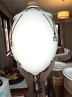 14 litre white ceramic water egg with a spherical quartz necklace and gold and silver triskelions further structuring the water inside