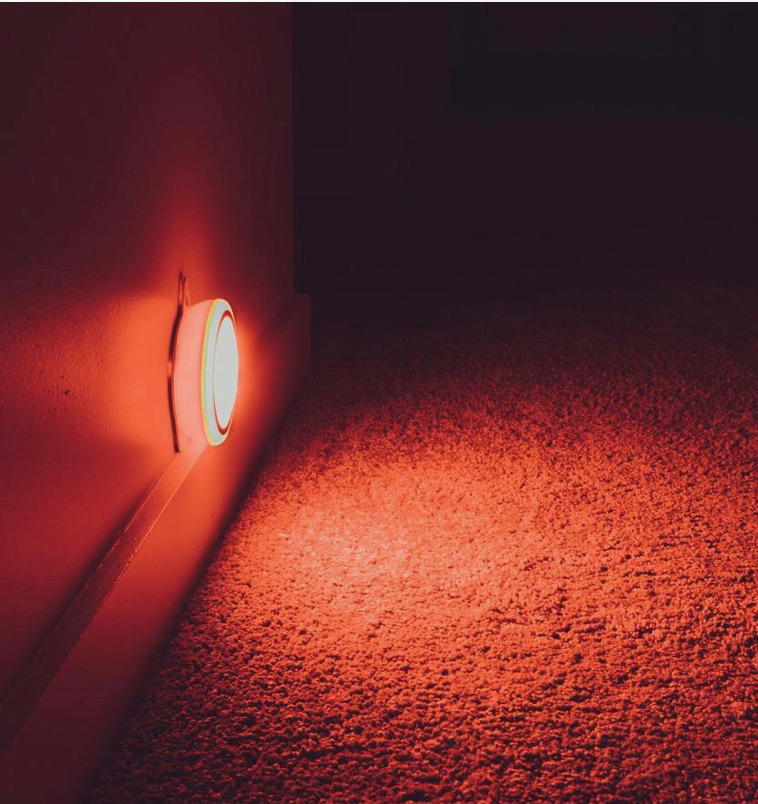 hexagonal red nightlight on on wall with carpet glow